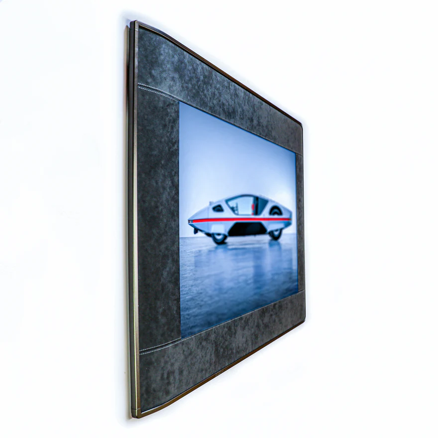 Side profile of a slim E-Ink picture frame with a dark frame and matboard